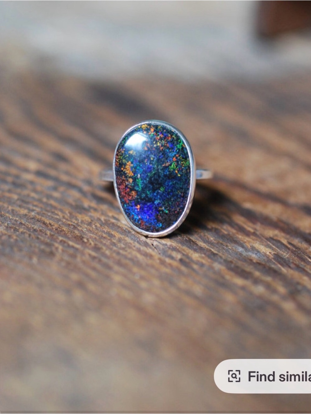 Black Andamooka opal , thin band size 8 . Ring fits a size 8 .